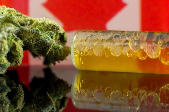 Cannabis flower and oil, with a Canadian flag in the background.